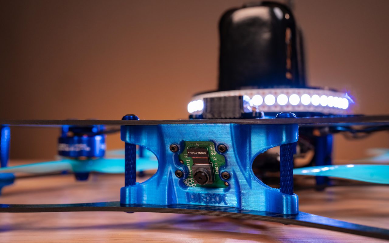 Close-up of a DEXI-5 with its LED ring lit blue.