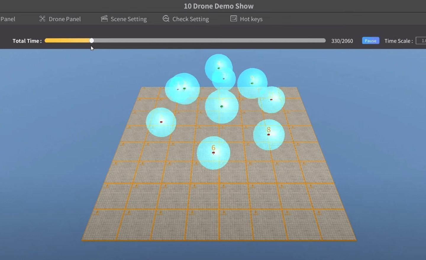 A show called 10 Drone Demo Show playing in the simulator: nine glowing cyan drones held in formation above a gridded ground plane, with a playback bar reading 330 of 2060.